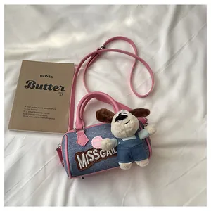 Detail of denim Boston bag with pink handles, MISSGAIL embroidery and cute puppy charm