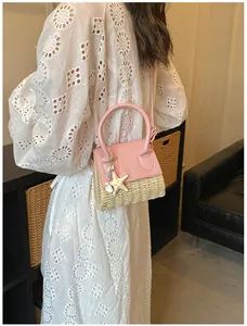 Detailed shot of mini straw bag with pink leather trim and starfish charm decoration