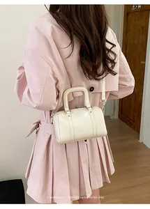 Detail of cream Boston bag in glossy leather with double handles and detachable strap