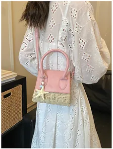Rear view of a pink leather and woven straw mini bag with a starfish charm on model