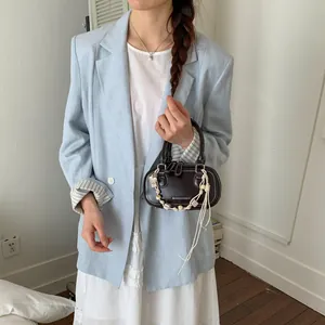 Minimalist dark brown leather Boston bag with white woven charm in a Korean style outfit