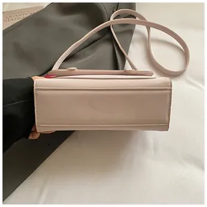 Detailed view of stitching and side structure of the pink leather square shoulder bag