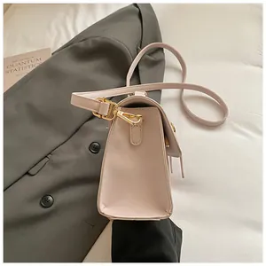 Detailed view of cream PU leather crossbody bag with elegant gold hardware buckles