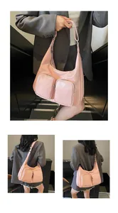 Detail view of pink PU leather tote featuring dual front pockets and wide shoulder strap