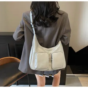 Detailed back view of a grey hobo bag showing its large capacity and double front zippers