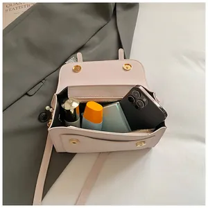 Interior view of small leather flap bag showing storage capacity for daily essentials
