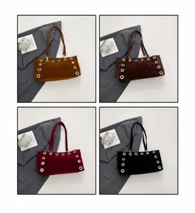 Detail view of retro velvet baguette bags in four colors with decorative eyelet accents