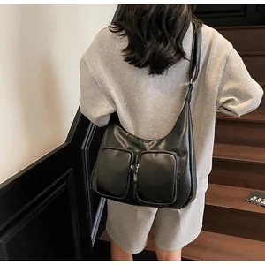 Detailed back view of a soft black PU leather underarm bag with double front zippers