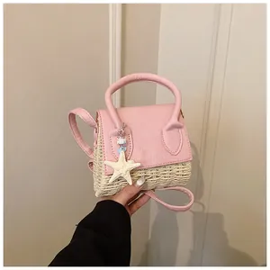 Detailed shot of a woven mini bag featuring a pink leather flap and a starfish charm