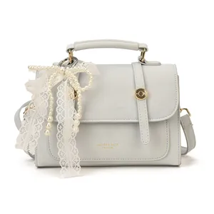 Light blue square handbag with top handle, pearl lace bow and adjustable shoulder strap