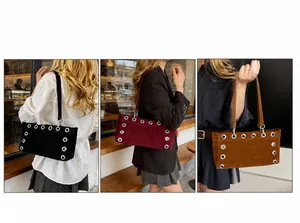 Detail of matte suede baguette bags with silver eyelet trim in black and burgundy