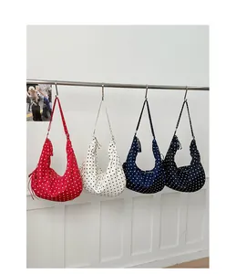 Details of colorful polka dot dumpling bags with adjustable straps in four colors