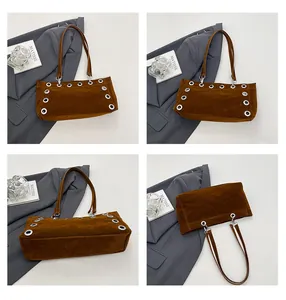 Detailed views of a dark brown suede baguette bag featuring large silver metal eyelets