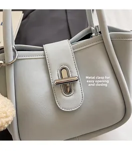 Detail of light blue lychee pattern bucket bag featuring a silver metal twist lock