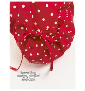 Close-up of the red polka dot fabric texture with bow drawstring design details