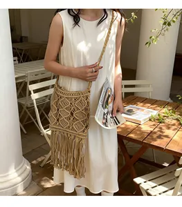 Detail of bohemian tassel crossbody bag with diamond weave pattern and long fringes