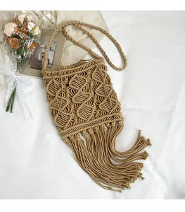 Close-up of bohemian woven bag featuring intricate diamond patterns and long fringe tassels