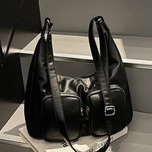Chic black glossy PU leather shoulder bag with dual zipper pockets and adjustable strap