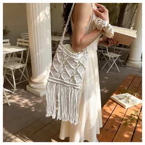 Close-up of bohemian macrame woven bag with detailed geometric patterns and long tassels