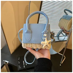 Detail of blue leather and straw bag with starfish charm and mirror reflection