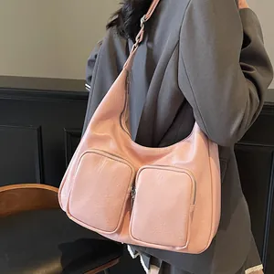 Pink faux leather hobo shoulder bag with double front zip pockets and wide strap