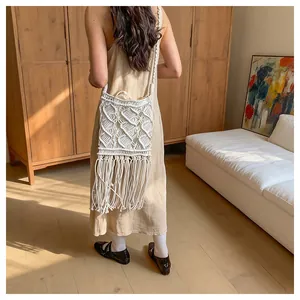 Detailed texture of bohemian straw bag with long tassels and intricate macrame weave