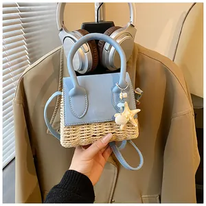 Detailed view of mini straw crossbody bag with starfish charm and round handle