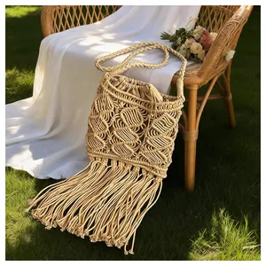 Detail of macrame shoulder bag with fringe tassel and woven geometric texture on a chair