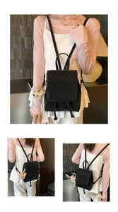 Close-up of black leather backpack with drawstring closure and cute plush bear charm