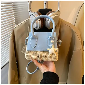 Close-up of mini straw bag featuring blue patchwork and decorative starfish charm