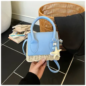 Detail showing mini straw texture bag with light blue leather and starfish charm