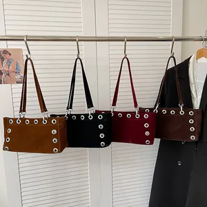 Frosted suede baguette bags in four colors with large metal eyelet details