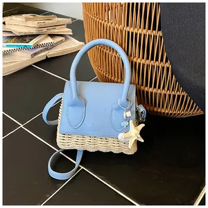 Detail of summer straw-textured mini bag in blue leather with starfish and shell charms