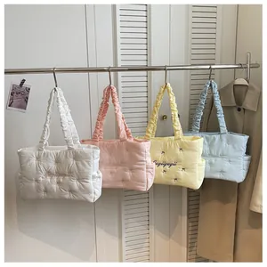 Quilted nylon tote bags in pastel colors featuring bow embroidery and ruffled handles