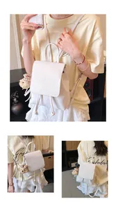 White PU leather mini backpack with drawstring closure and cute teddy bear charm detail