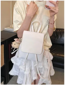White PU leather backpack for women with a cute plush bear charm on the side pocket