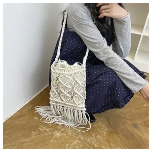 Detail of macrame tassel shoulder bag with cream cotton rope weaving and inner drawstring pouch