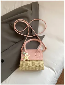 Detail of pink straw-textured mini bag with ocean charms like starfish and shells