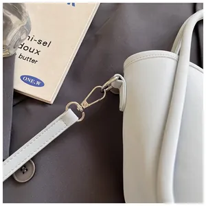 Close-up of light blue leather bucket bag detailing silver hardware and stitching