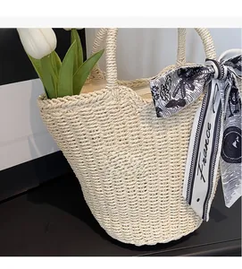 Detailed texture of beige woven tote bag featuring decorative France print silk scarf