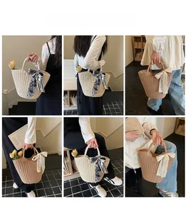 Detail of handwoven straw tote with silk scarf and lace bow in cream and khaki