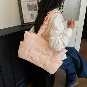 Pink quilted nylon tote bag with ruffled straps and embroidery for daily casual use