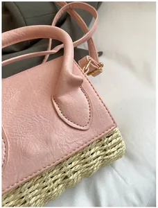 Detail of pink faux leather and straw texture stitching on mini crossbody handbag