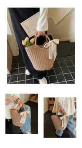 Detail of handwoven straw tote bag featuring white lace tassel bow and wave edge trim
