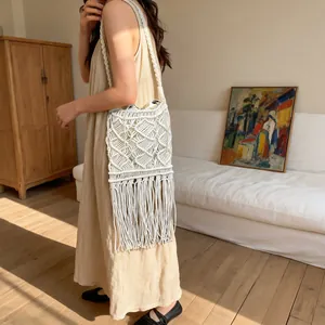 Handmade white woven straw bag with long tassels for summer beach and boho style