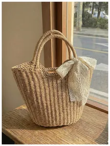 Detailed texture of straw weave bucket bag featuring a delicate white lace bow detail