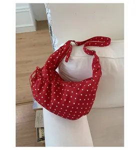 Detail of red and white polka dot canvas shoulder bag with pleated rouching detail