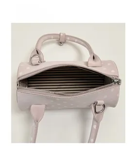 Top view of the pink polka dot bowling bag showing the striped lining and interior capacity