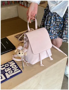 Pink PU leather mini backpack detail with drawstring closure and cute teddy bear charm