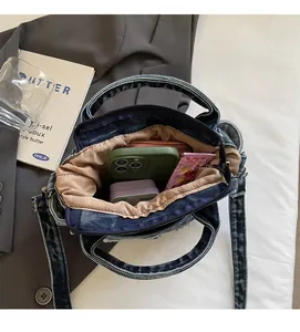 Detailed view of spacious interior of blue denim tote bag with light brown lining